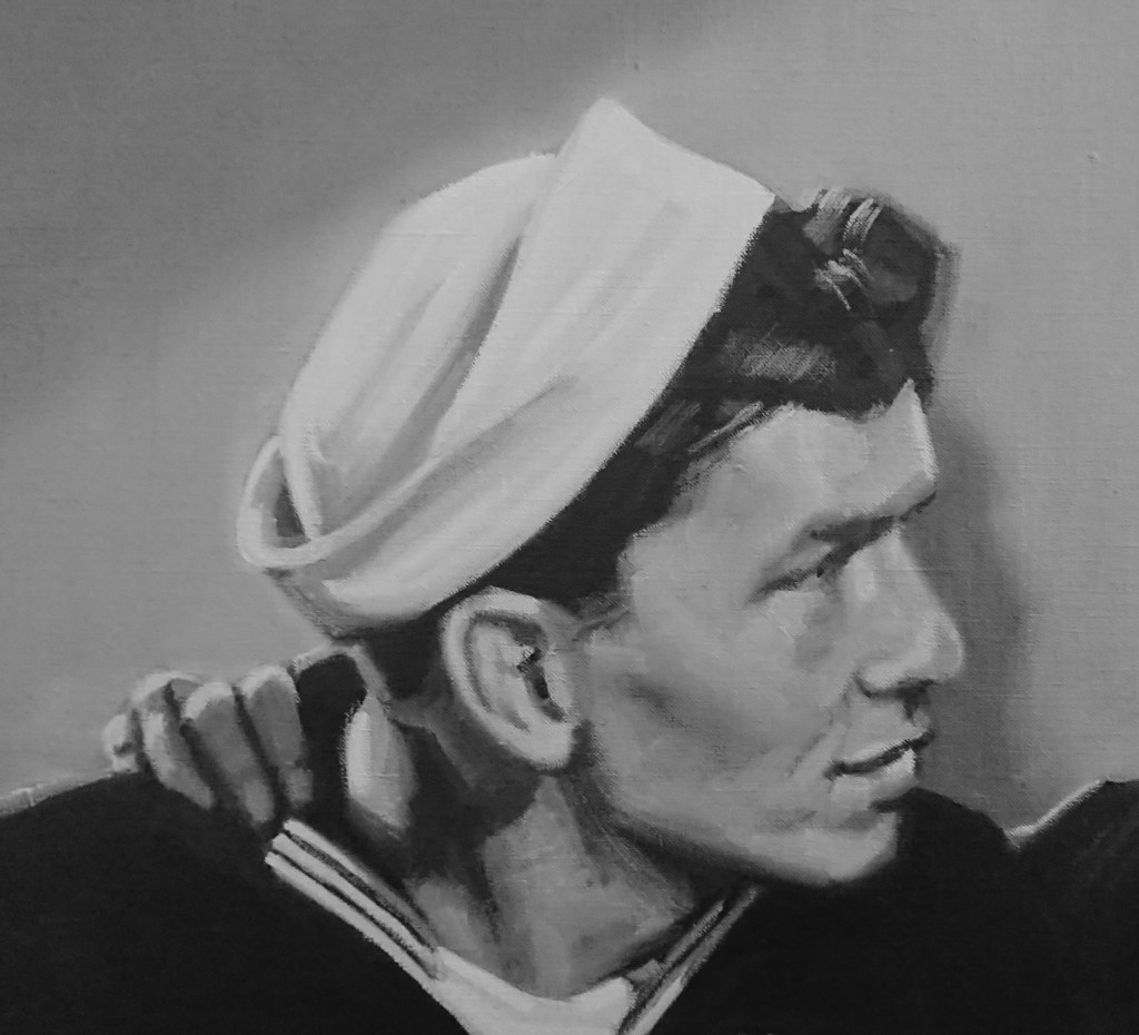 Close-up portrait of a young sailor in uniform, wearing a white hat and looking thoughtfully to the side.